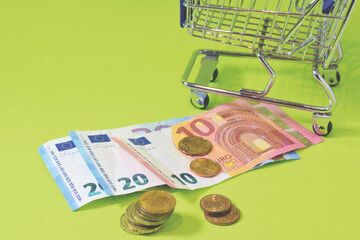 Euro coins and banknotes, green background. Close up.