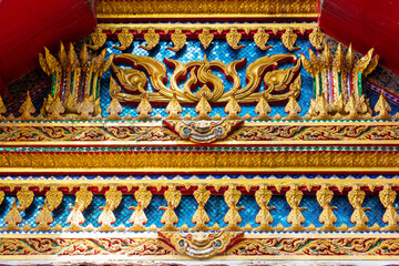 Fototapeta premium Close-up reveals ornate details of a temple's architectural elements, Golden thai art pattern in temple roof of Thailand