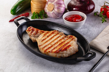 Tasty hot grilled bone steak served sauce