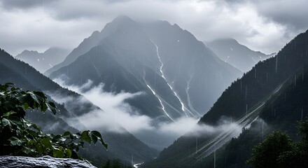 Majestic mountains shrouded in mist and rain, showcasing dramatic landscapes and nature's beauty
