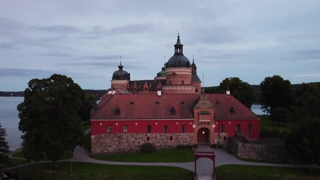 Aerial view of Gripsholm Castle in Mariefred, Sweden. Gripsholm Castle is a historical fortress in Mariefred, Sweden, located beside a serene lake. The structure features classic circular towers 
