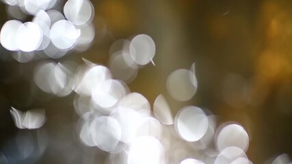 Abstract Gold blurry bokeh background with lights particles on dark background. Defocused photo effect. Slow motion animation. Abstract blur with blinking bokeh lights background - Powered by Adobe