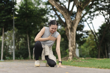 Asian women collapsing from chest pain during outdoor workout, showing signs of possible heart...