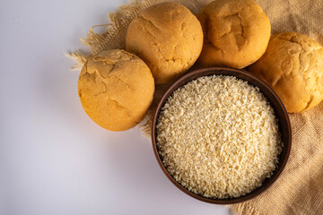 Breadcrumbs for breading in a bowl next to round buns. Top view. Space for text