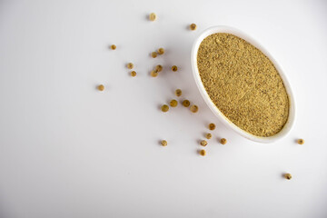 white ground pepper in a ceramic bowl on a white background