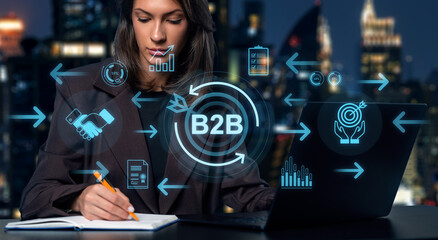 Businesswoman planning B2B strategy with digital icons and data