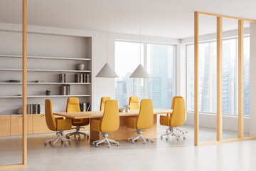 Modern conference room interior with yellow chairs and wooden table in office space overlooking city skyline through glass windows and shelving in background. 3D Rendering © ImageFlow