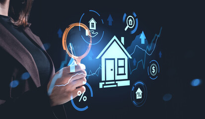 Woman holding magnifying glass near digital house hologram with real estate data and investment...