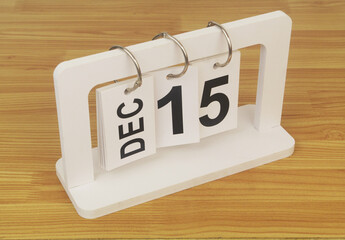 December, 15 on calendar on wooden table close-up.