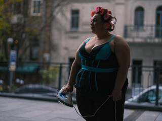 Curler Woman in lingerie with Iron on Street Side View