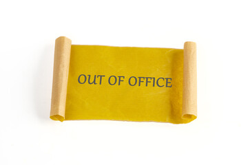 A bright yellow scroll with bold out of office text on a white surface provides a cheerful, professional way to notify others of your absence