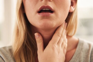 portrait of a young woman pressing her neck because of the throat pain, 