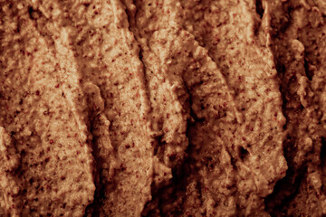 Chocolate ice cream with nuts and banana, texture. Chocolate smoothie cocktail close-up. Nut paste as a background.