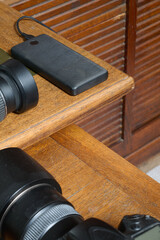 Powerbank and lenses from camera on dekstop