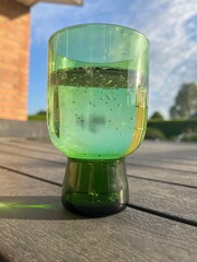 glass of sparkling water in a green glass