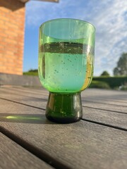 glass of sparkling water in a green glass