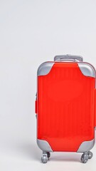 Bright red suitcase with silver accents on a white background