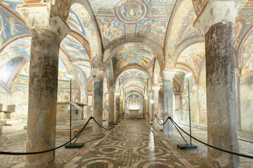 Anagni cathedral crypt showcasing ancient frescoes and cosmatesque floor, Italy