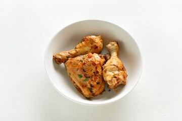 Baked chicken meat with herbs in bowl