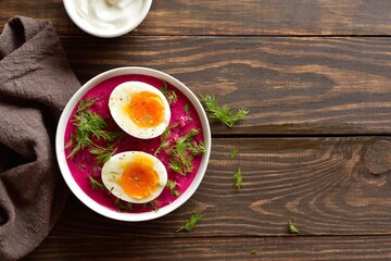 Homemade cold summer beet soup with cucumbers, dill and egg