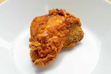crispy fried chicken on white plate close up