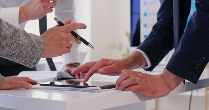 Office close up workers, employee checking financial document on laptop screen, working with statistics, consulting client, showing client or colleague annual financial report analyzing small business
