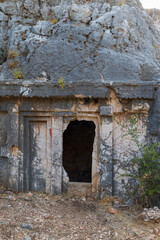Vertical outdoor photo featuring the entrance to the Acdam Doric tomb in Antiphellos