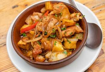 Delicious chicken stew with potatoes and vegetables served in a rustic bowl
