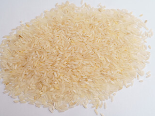 Uncooked Long-Grain Rice Spread on White Surface
