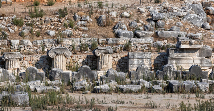 Weathered ancient ruins reveal crumbling colonnade fragments