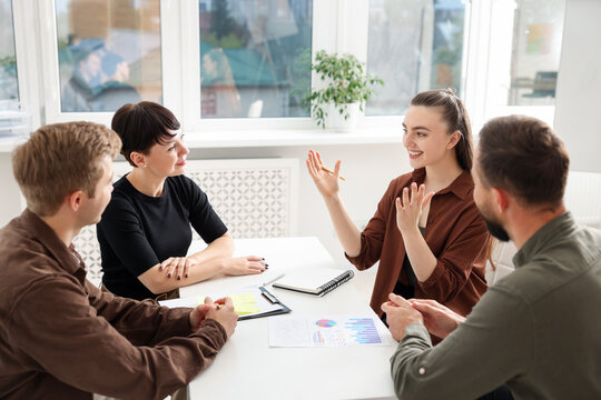 Business process. Colleagues working together at desk in office