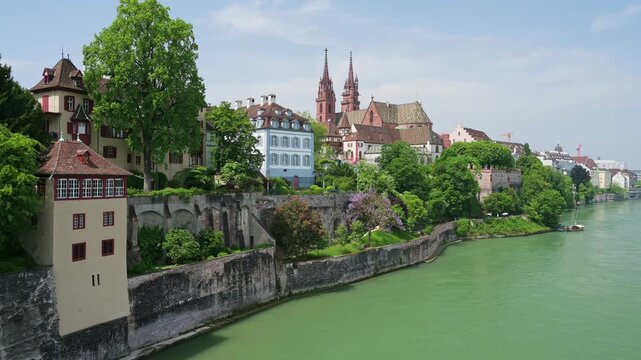 Basel, Switzerland &mdash; Scenic summer view of the Basel Cathedral (Basler M&uuml;nster) and historic old town from the Rhine riverbank