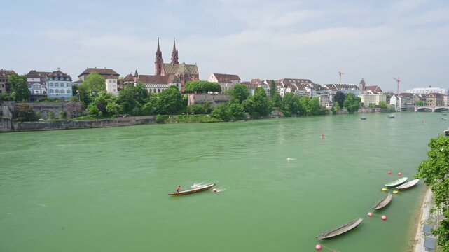 Basel, Switzerland &mdash; Scenic summer view of the Basel Cathedral (Basler M&uuml;nster) and historic old town from the Rhine riverbank