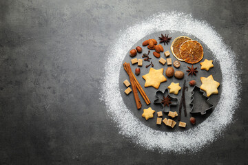 Christmas celebration. Circle made with flour, cookies and spices on grey table, flat lay. Space for text
