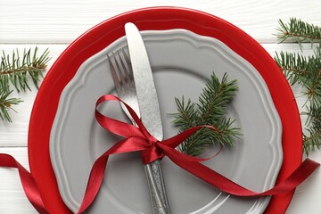 Festive table setting with Christmas decor on white wooden background, flat lay