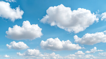 Fototapeta premium Fluffy white clouds float in bright turquoise sky, creating serene summer atmosphere