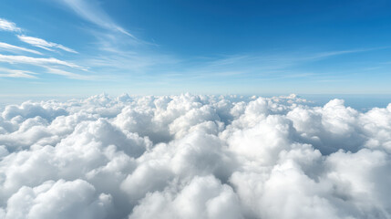 Fototapeta premium Fluffy white clouds stretch across bright blue sky, creating serene and uplifting atmosphere