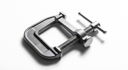 Clamp: A sturdy metal clamp stands in stark relief, casting a shadow and highlighting its intricate design and robust construction, embodying the essence of precision and utility.