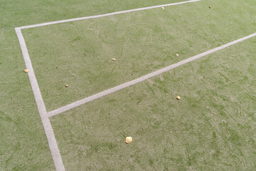 Artificial green turf with white painted lines on a open sports field