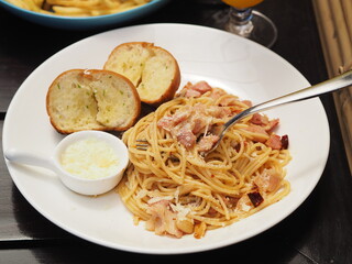 Spaghetti Aglio e Olio with Fork Under Pasta and Garlic Bread at Hotel Dinner in Phuket, Bangkok
