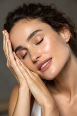 Fototapeta premium Woman with Radiant Skin and Natural Beauty, Hands Gently Touching Face 
