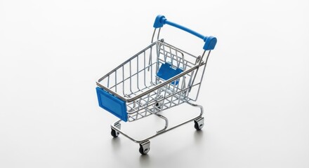 Small, empty metal shopping cart with blue accents on a white surface