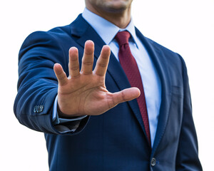 Confident businessman in sharp navy suit with red tie signals stop or warning with open hand gesture in professional setting