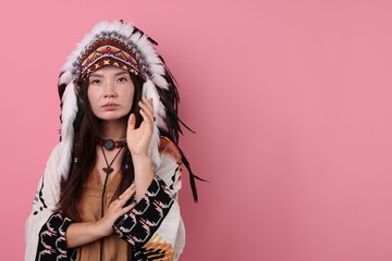 Shaman woman in native American Indian headdress on pink background, space for text
