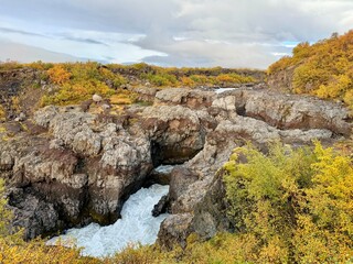 Hraunfossar Waterfalls in Western Iceland, Flowing from Lava Fields with Autumn Colors and Scenic Nature