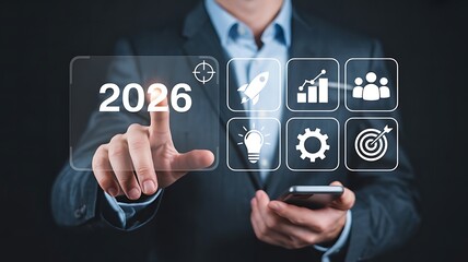 Businessman Interacting with Futuristic Digital Interface Featuring Target and Innovation Icons for 2026 Goals