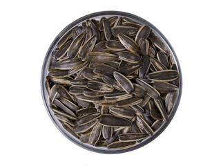 Striped sunflower seeds in a glass bowl isolated on white background.