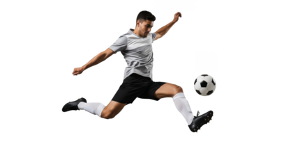 Leaping athlete powerfully kicks soccer ball