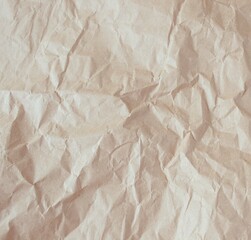 Brown crumpled paper texture or background for design with copy space for text, top view. Packaging material.