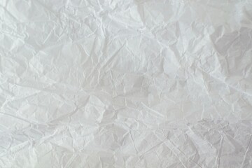 Crumpled white paper background. Crumpled paper texture, top view, copy space.